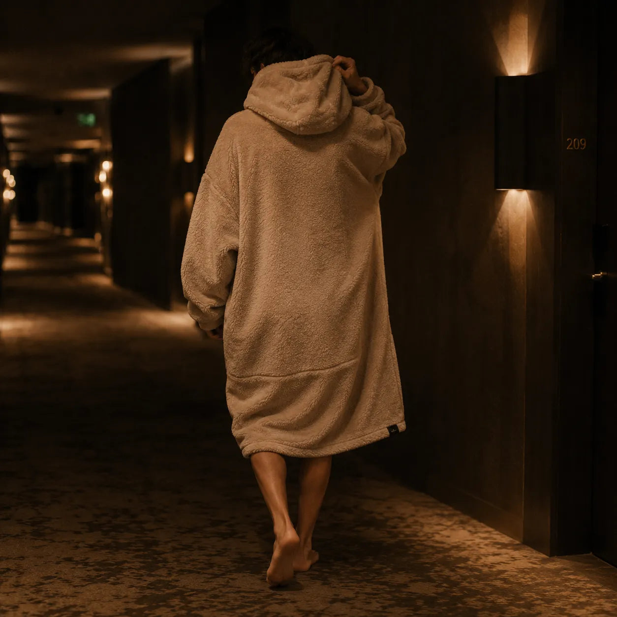 The Snoodie in a corridor — oversized luxury hoodie by veyl.